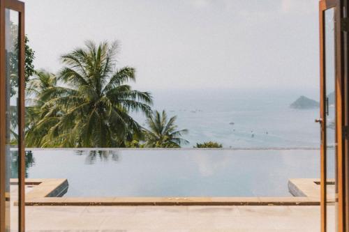a view of the ocean from a resort swimming pool at Perfect View Pool Villa in Koh Tao
