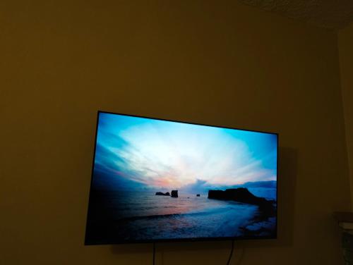 una pantalla de televisión con una foto de la playa en Elite stay, en Embu