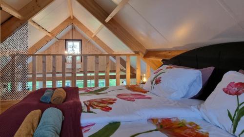 a bed in the attic of a room at GuestHouse Amsterdam "City Farmer" lodge with a skyline view in the countryside in Amsterdam