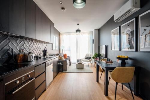 a kitchen with a table and a dining room at Midnight Moonshine Loft in Launceston