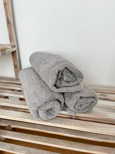 a pile of towels sitting on top of a ladder at APARTMENT ON THE ROAD S-61 in Szypliszki