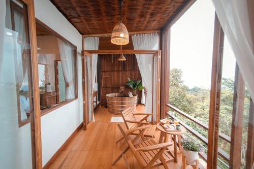 a balcony with two chairs and a table on it at U villa in Ban Huai Khai