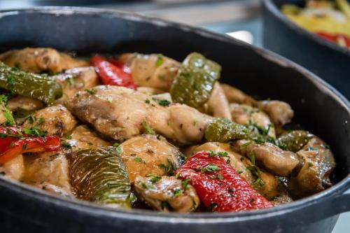 a pan of food with meat and vegetables at ALEGRIA Colonial Mar Aquafun in Roquetas de Mar