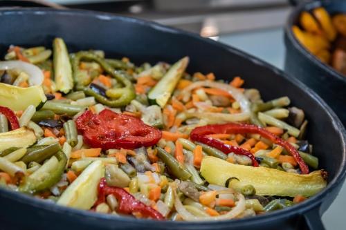 a pan filled with vegetables in at ALEGRIA Colonial Mar Aquafun in Roquetas de Mar