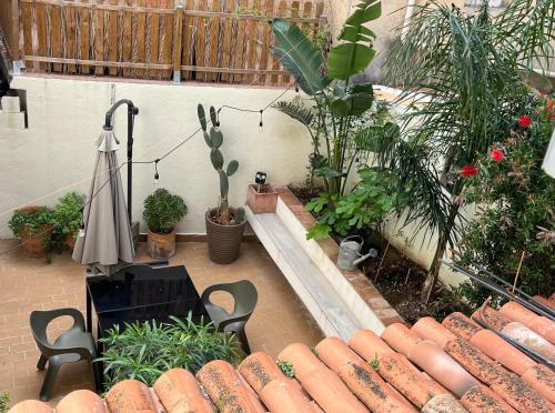 a courtyard with a pool with plants and an umbrella at Home à la mer in La Ciotat