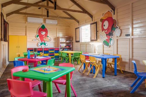 a brightly colored classroom with tables and chairs at ALEGRIA Colonial Mar Aquafun in Roquetas de Mar