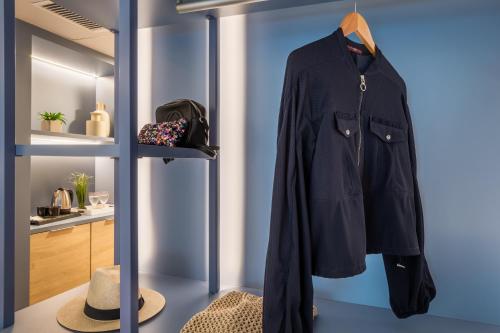 a coat hanging on a rack in a room at ALEGRIA Colonial Mar Aquafun in Roquetas de Mar