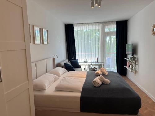 a bedroom with a bed with two shoes on it at Meer Heimat am Steinhuder Meer in Wunstorf