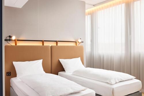 Postel nebo postele na pokoji v ubytování H2 Hotel Wien Schönbrunn