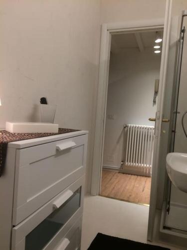 a white bathroom with a sink and a toilet at Jill&Jade's Apartment in Como