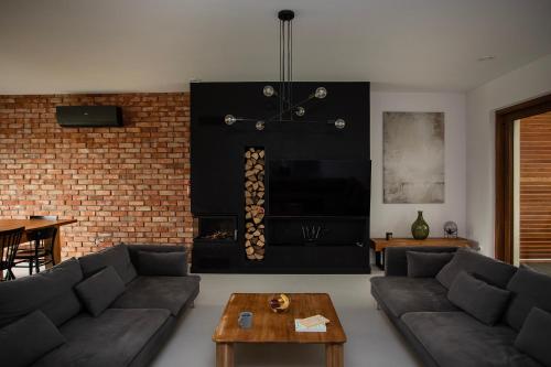 a living room with a couch and a fireplace at Lake House Borowe in Borowe