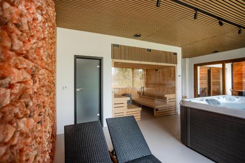 a bathroom with a tub and a sink in it at Lake House Borowe in Borowe