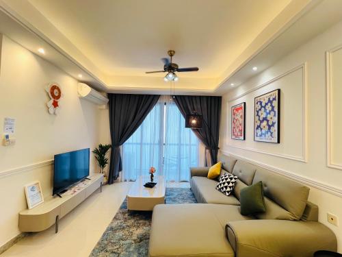 a living room with a couch and a tv at R&F PRINCESS COVE at ANJU in Johor Bahru