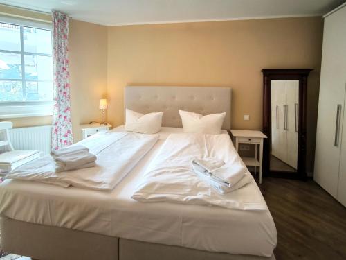 バーベにあるHaus Meeresblick FeWo Godewind A 1の窓付きの客室で、白い大型ベッド1台が備わります。