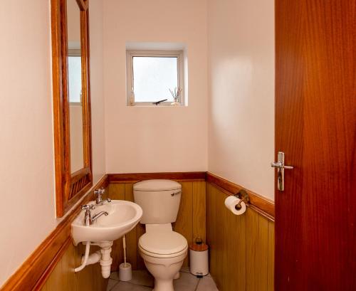 a bathroom with a toilet and a sink at Pikkewyn Unit 1 in Agulhas