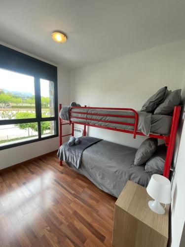 a bedroom with two bunk beds and a window at Apartamento en Olvan 2 - ALBERGA in Olvan