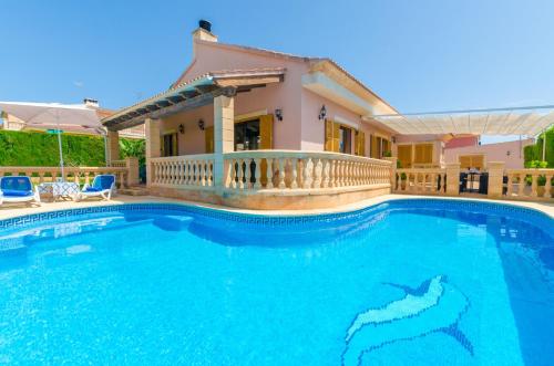 a large swimming pool in front of a house at Can Fama in Badia Gran