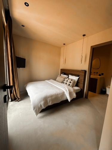 a bedroom with a bed with white sheets and pillows at Na Xamena in La Croix-Valmer