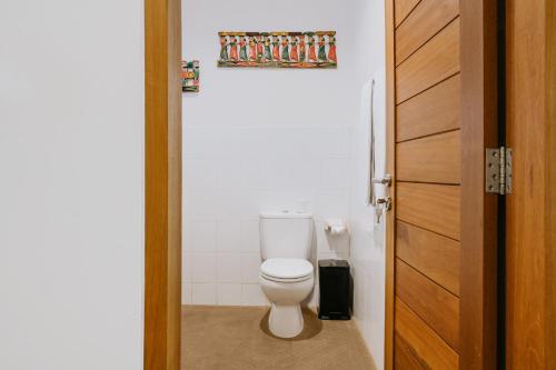 bagno con servizi igienici bianchi in camera di Jati Home Stay ad Ubud