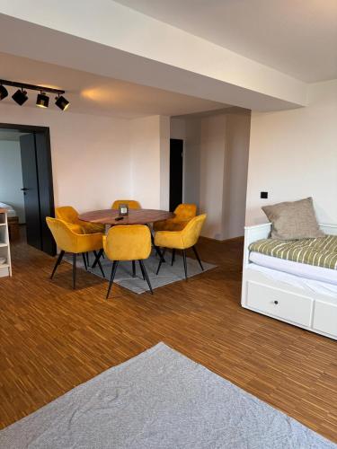a bedroom with a table and chairs and a bed at SunDeck Weimar in Buttelstedt