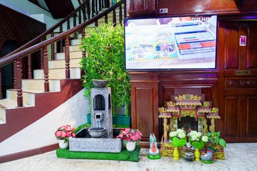 a building with a staircase with a shrine and flowers at Marine paradise Encore in Pattaya South
