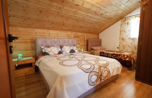 sypialnia z dużym łóżkiem w drewnianym pokoju w obiekcie Samuela Cozy Retreat w mieście Berat