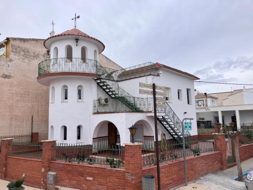 an old building with a lighthouse on the side of it at Casa La Torre de la Balsa de Cela in El Canalito