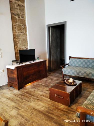 a living room with a couch and a table at Flora's Traditional House in Malona Village
