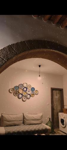 a room with a bunch of plates on the wall at Flora's Traditional House in Malona Village