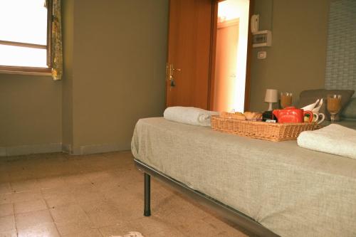 a bed with a basket of food on top of it at B&B SEBA e PAOLA in Sonnino
