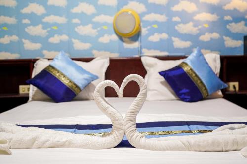 two swans made out of towels on a bed at Marine paradise Encore in Pattaya South