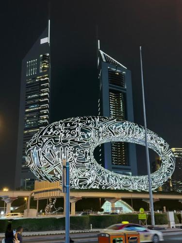 una gran escultura de metal en el lateral de un edificio en 2 Bedroom Entire Furnished- Future Museum & Trade Center, en Dubái