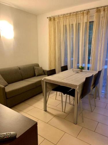 a living room with a table and a couch at Casa Piccola FeWo in Nago-Torbole
