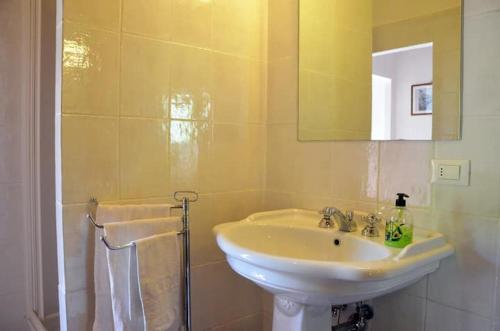 a bathroom with a sink and a mirror at Villa Olivo in Lastra a Signa