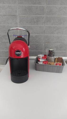 a red toaster sitting on top of a counter at Casa Vacanza Marano in Mascali
