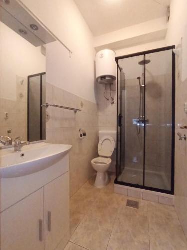 a bathroom with a shower and a sink and a toilet at Apartment Bella Costa I in Kaštela