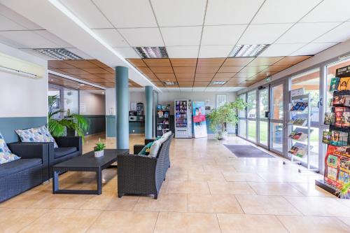 a lobby of a store with couches and a table at Appart'City Classic Nantes - Carquefou in Carquefou