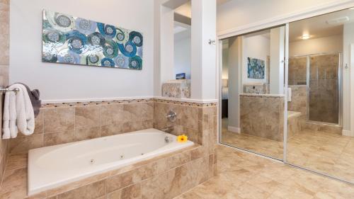 a large bathroom with a tub and a shower at INSPIRATION VILLA Inspiring 2BR Kulalani Home with Private Beach Club in Waikoloa