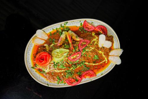 a plate of food with meat and vegetables on a table at Marine paradise Encore in Pattaya South