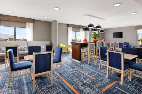 a lobby with chairs and tables and a bar at Hampton Inn Laredo in Laredo