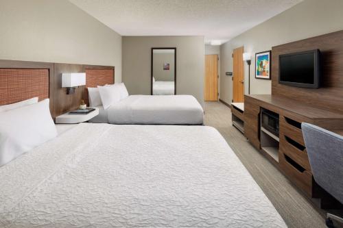 a hotel room with a large bed and a flat screen tv at Hampton Inn Laredo in Laredo