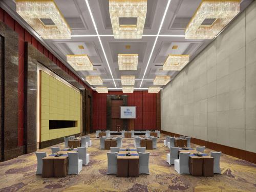 a large room with tables and chandeliers at Hilton Beijing Capital Airport in Shunyi