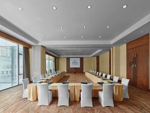 a large conference room with a long table and chairs at Hilton Beijing Capital Airport in Shunyi