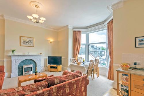 a living room with a couch and a fireplace at Keswick View in Keswick