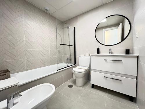 a bathroom with a sink toilet and a mirror at PUSHE Playa Granada Beach & Golf 28 in Motril