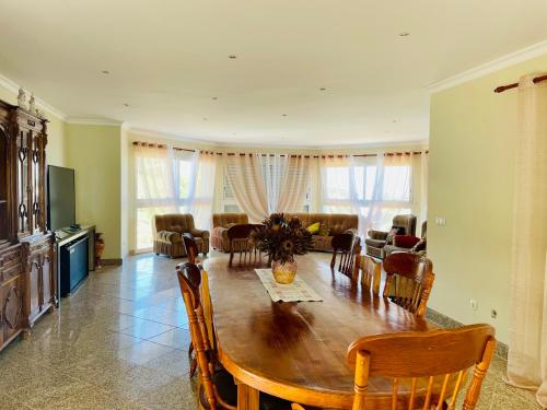 a living room with a wooden table and chairs at Belle Vue in São Jorge