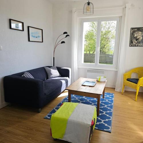 a living room with a couch and a coffee table at Charmante maison bretonne vue mer proche des plus belles plages in Landéda