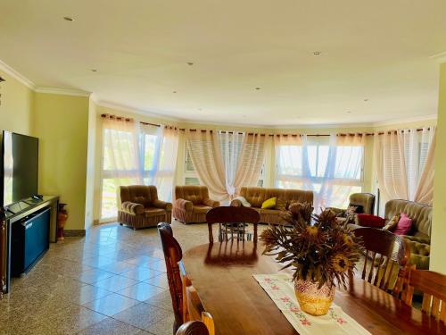 a living room with a table and chairs and a living room at Belle Vue in São Jorge