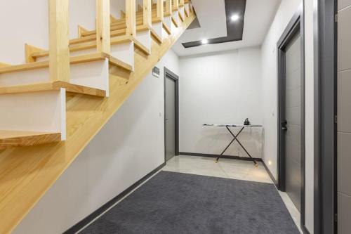 a hallway with wooden stairs and a door at 4-3 Yatak Odalı Büyük Daire Kaleiçi Yakını in Antalya