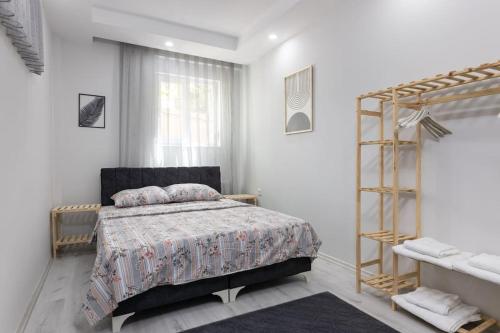 a bedroom with a bed and a book shelf at 4-3 Yatak Odalı Büyük Daire Kaleiçi Yakını in Antalya